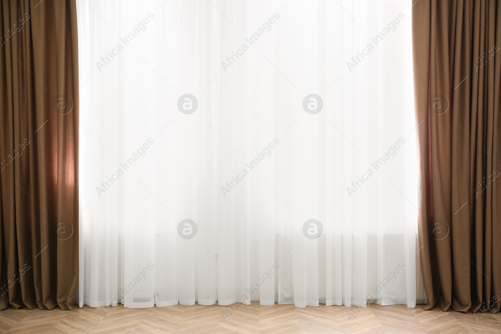 Windows with elegant curtains in modern room Photo of Windows with elegant curtains in modern room
