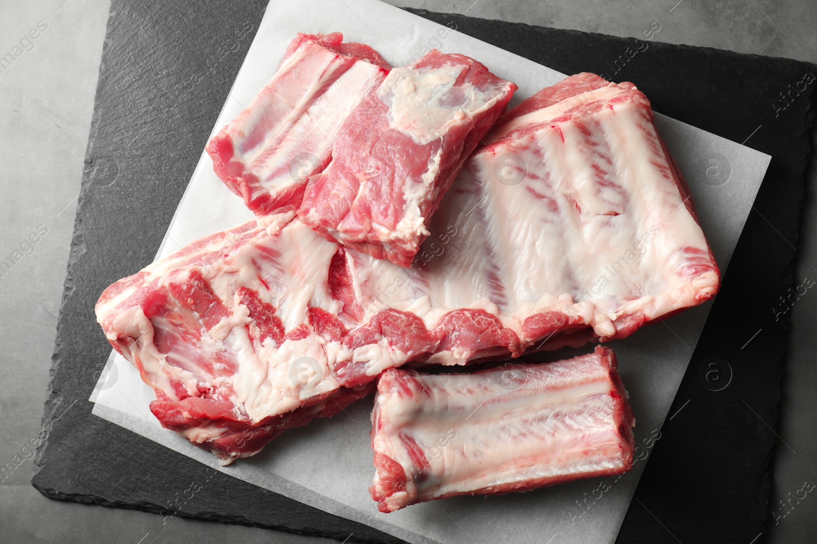 Raw pork ribs on grey table, top view Photo of Raw pork ribs on grey table, top view