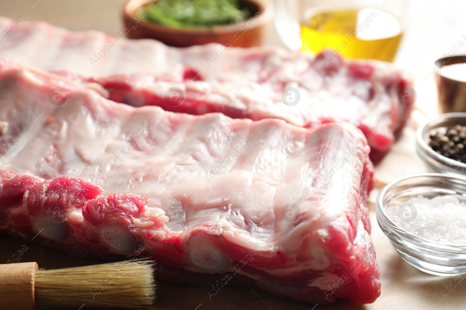 Raw pork ribs and spices on wooden table, closeup Photo of Raw pork ribs and spices on wooden table, closeup