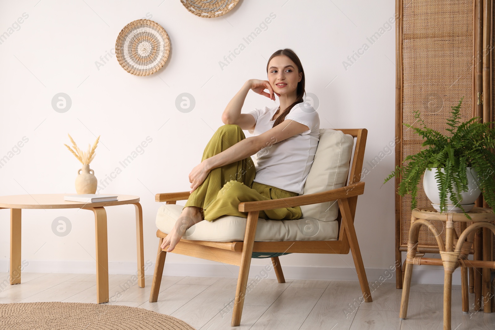 Beautiful woman relaxing in comfortable armchair at home Photo of Beautiful woman relaxing in comfortable armchair at home