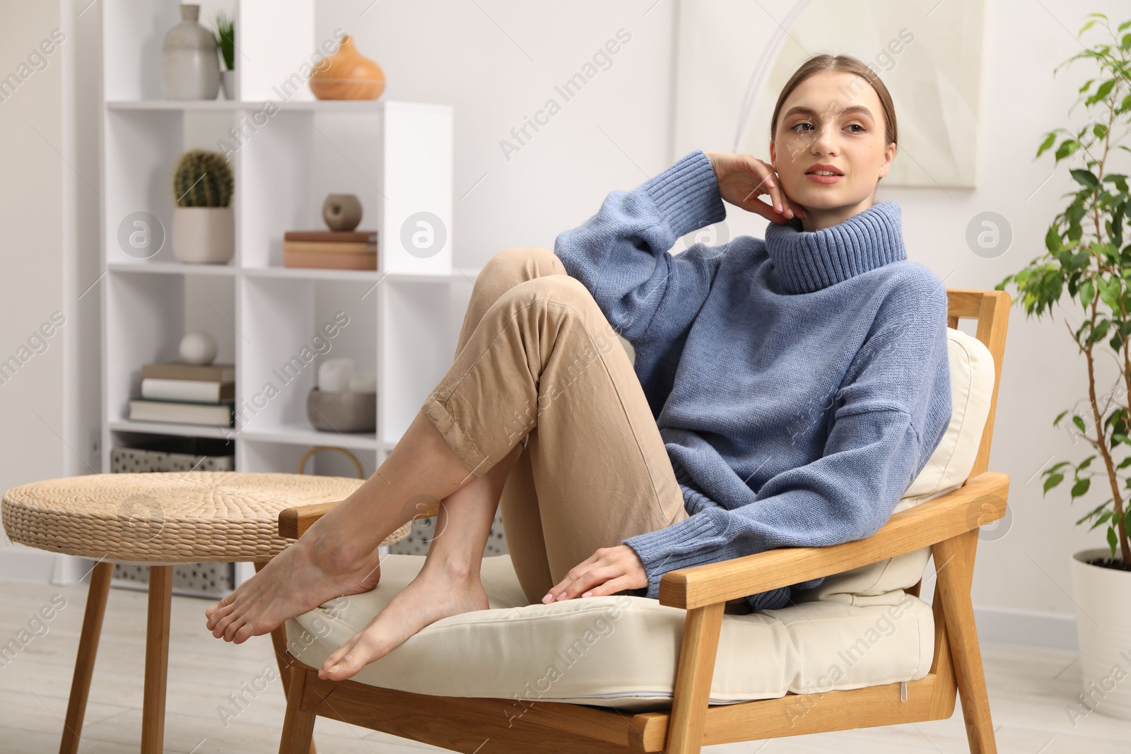 Beautiful woman relaxing in comfortable armchair at home Photo of Beautiful woman relaxing in comfortable armchair at home