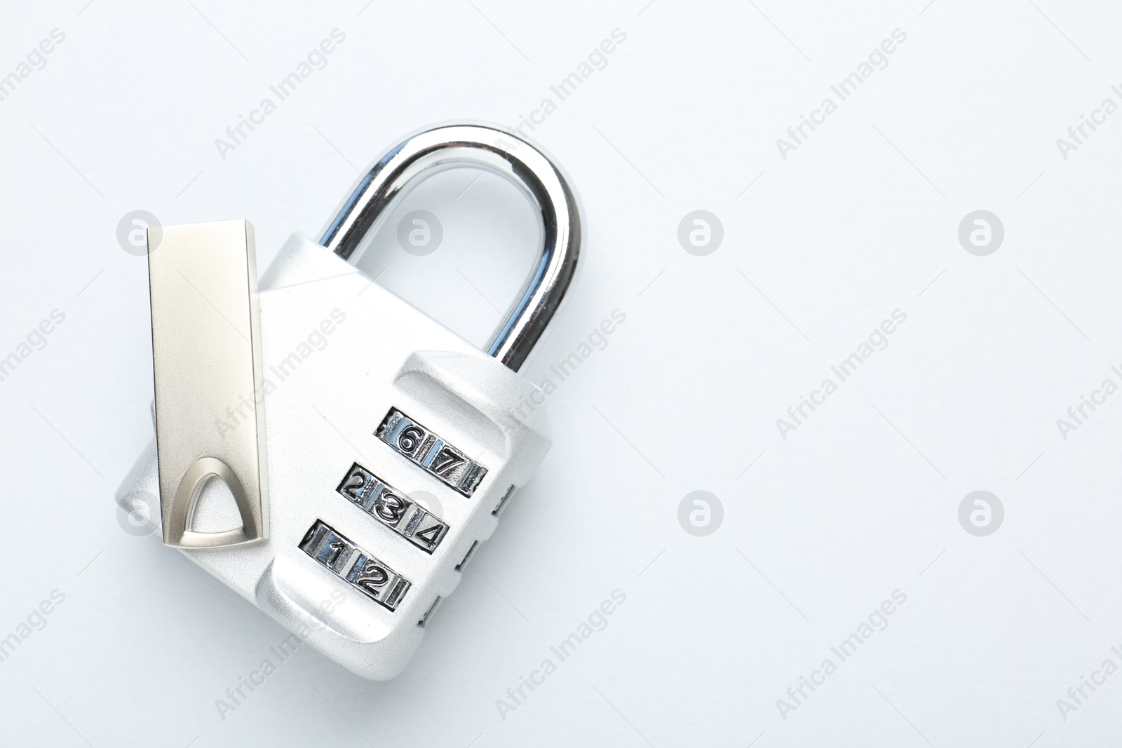 Flash drive and combination padlock on white background, top view Photo of Flash drive and combination padlock on white background, top view