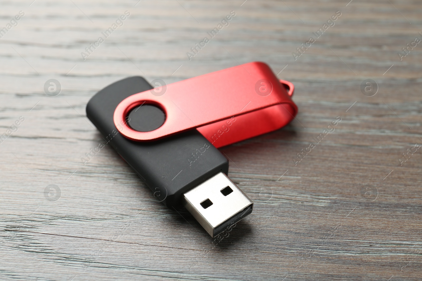 One flash drive on wooden background, closeup Photo of One flash drive on wooden background, closeup