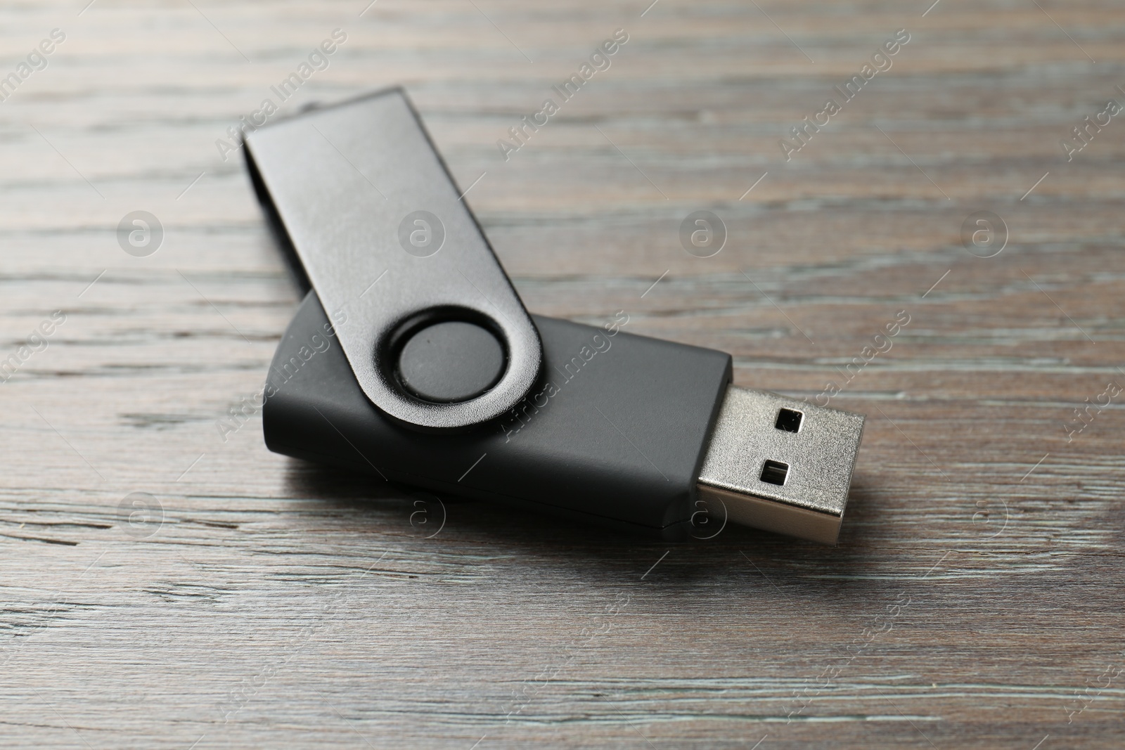 One flash drive on wooden background, closeup Photo of One flash drive on wooden background, closeup