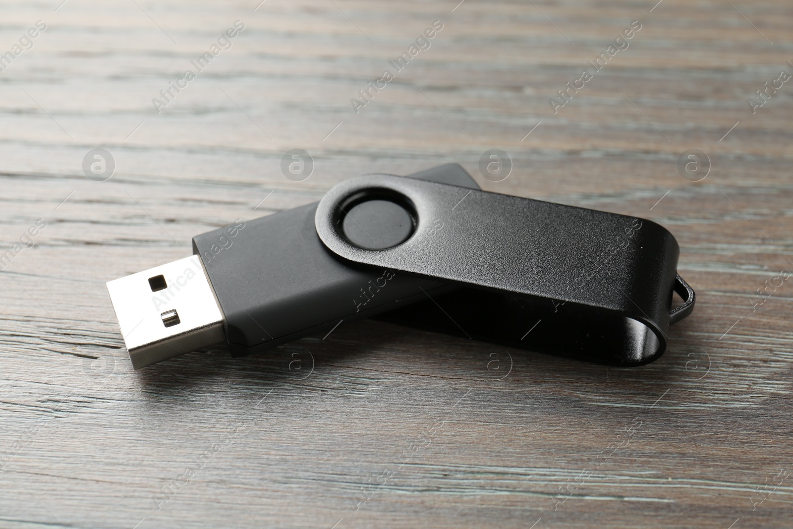One flash drive on wooden background, closeup Photo of One flash drive on wooden background, closeup