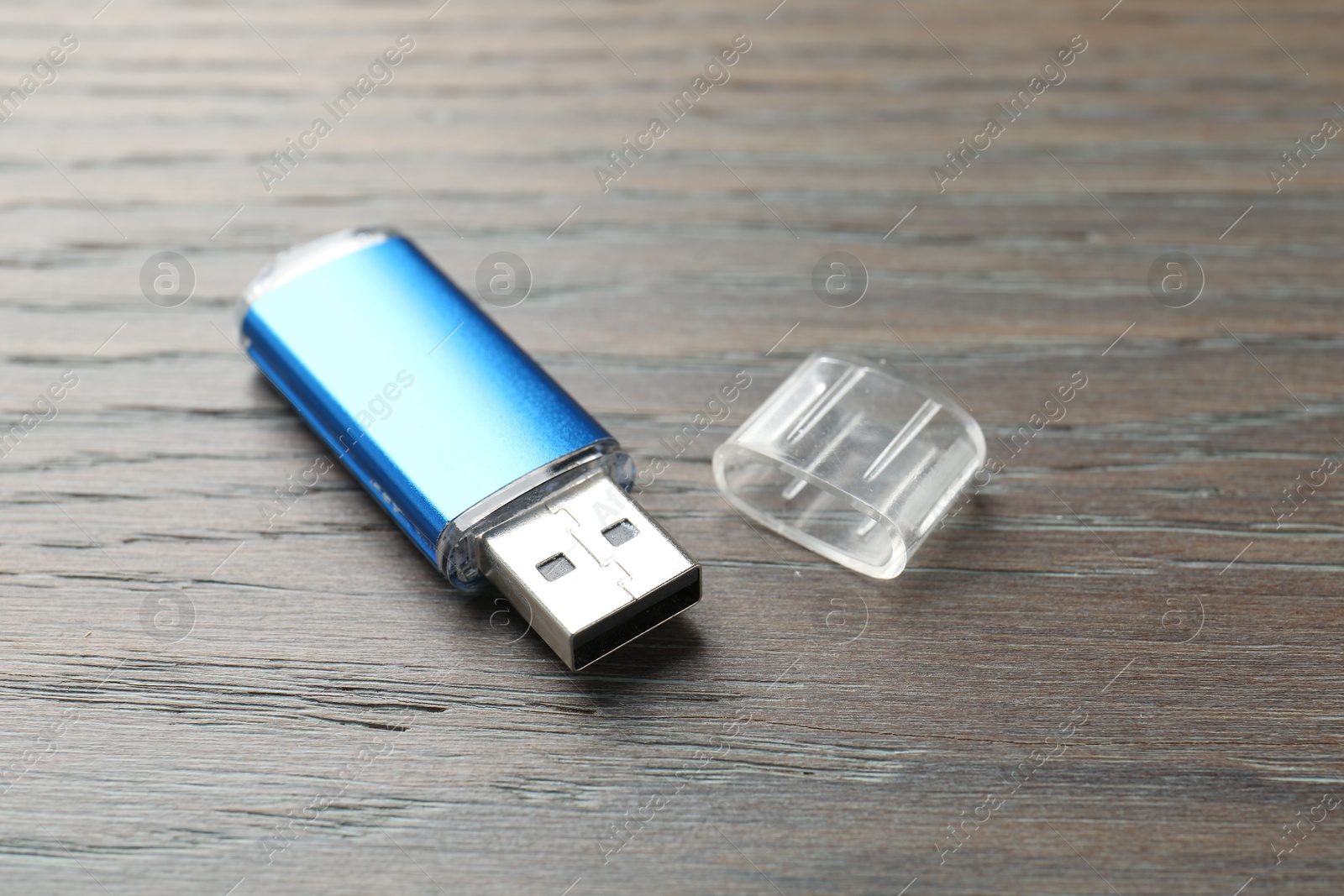 One flash drive on wooden background, closeup Photo of One flash drive on wooden background, closeup