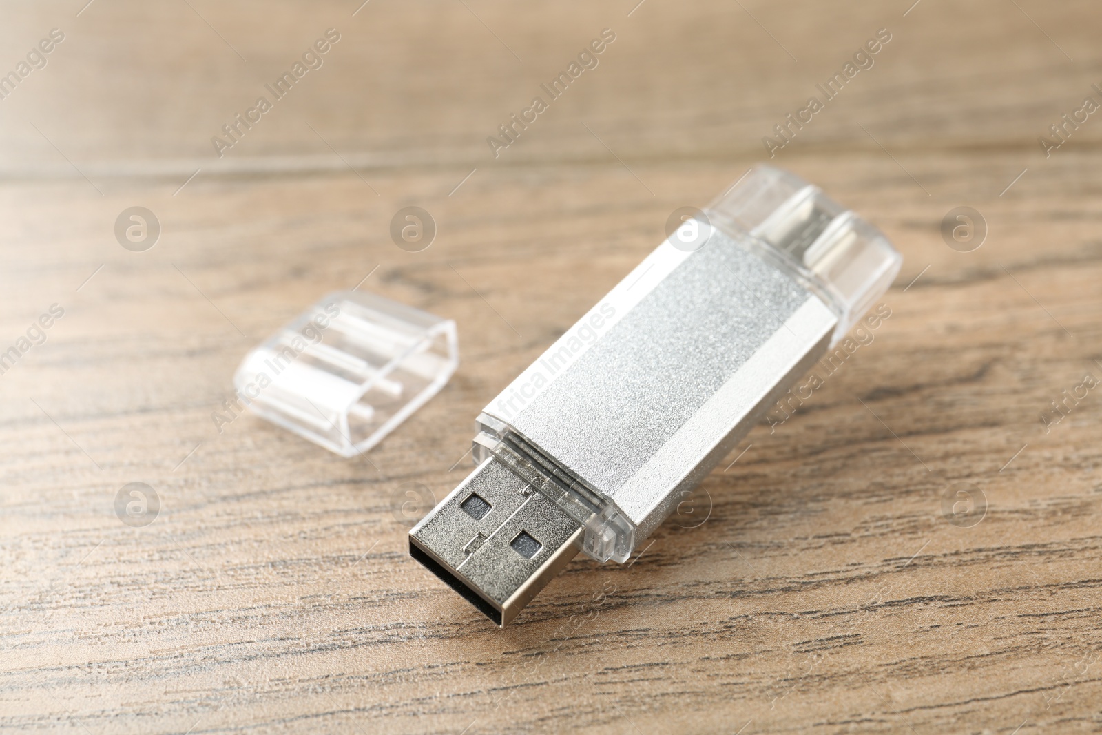 One flash drive on wooden background, closeup Photo of One flash drive on wooden background, closeup