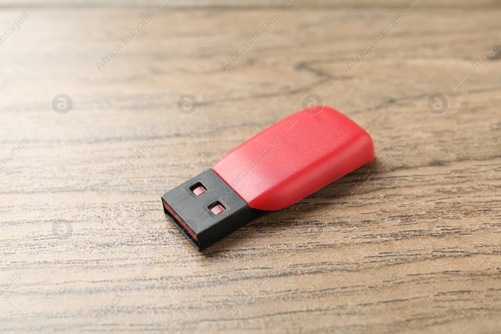 One flash drive on wooden background, closeup Photo of One flash drive on wooden background, closeup
