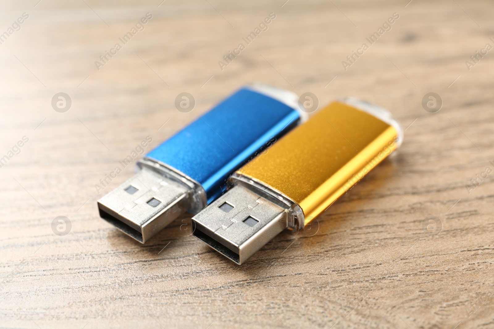 Two flash drives on wooden background, closeup Photo of Two flash drives on wooden background, closeup
