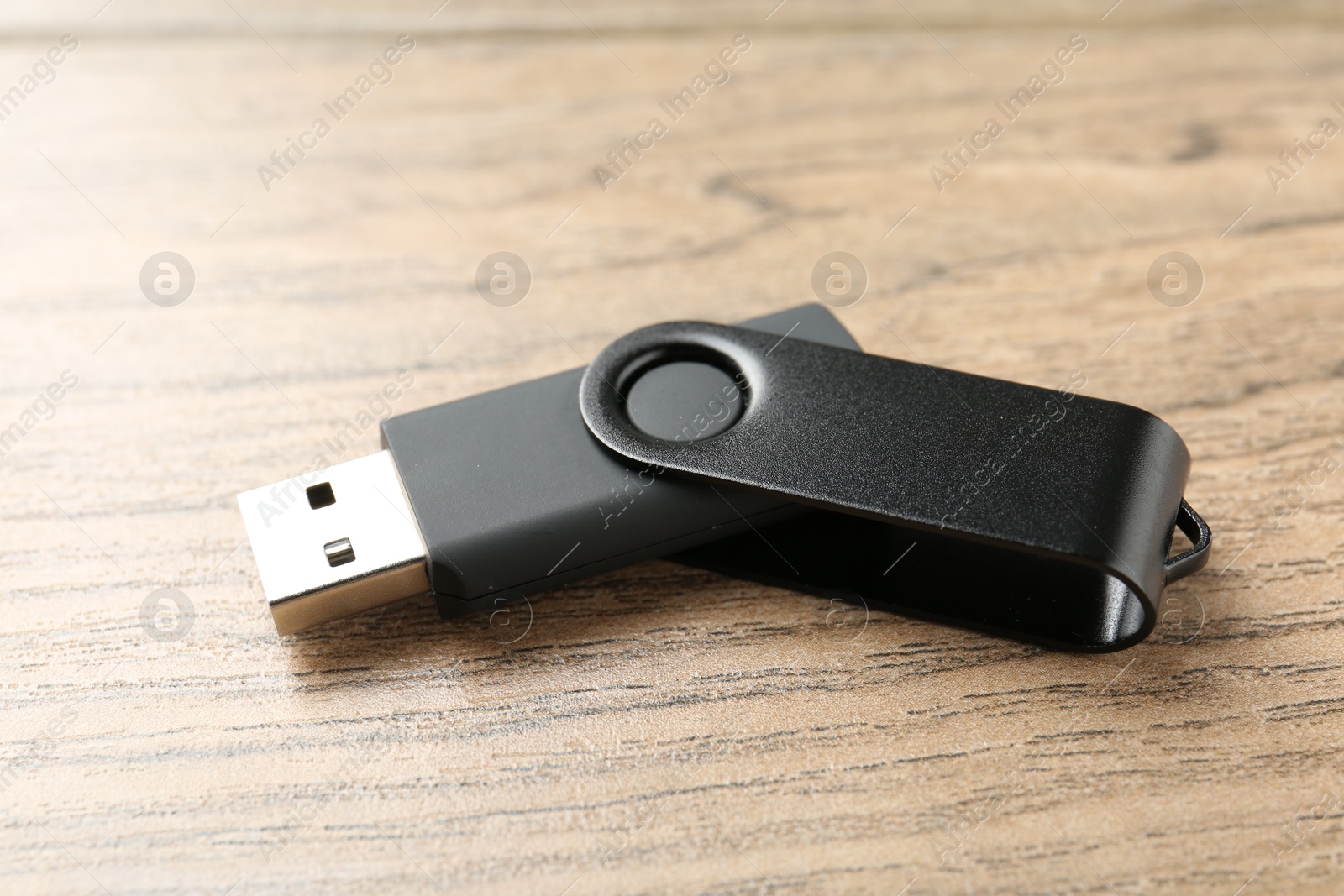 One flash drive on wooden background, closeup Photo of One flash drive on wooden background, closeup