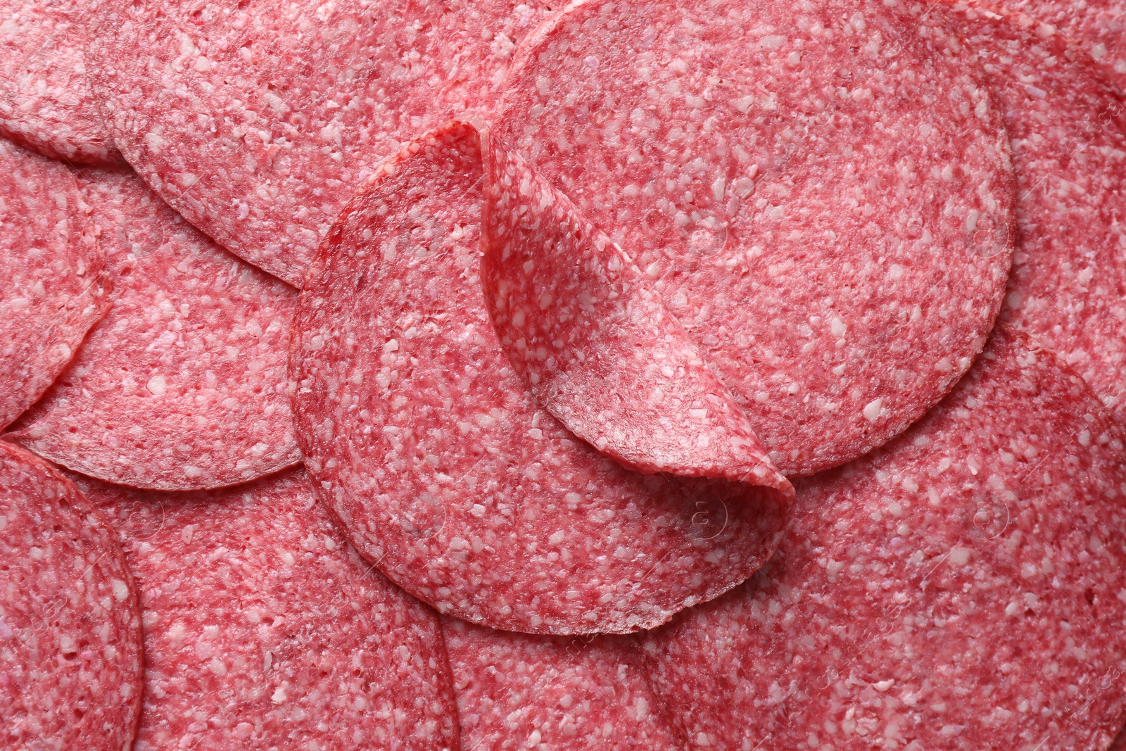 Photo of Slices of tasty smoked sausage as background, top view