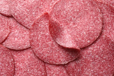 Photo of Slices of tasty smoked sausage as background, top view