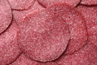 Photo of Slices of tasty smoked sausage as background, top view