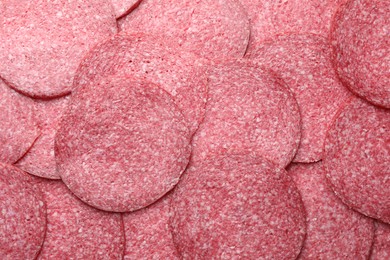 Photo of Slices of tasty smoked sausage as background, top view