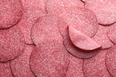 Photo of Slices of tasty smoked sausage as background, top view
