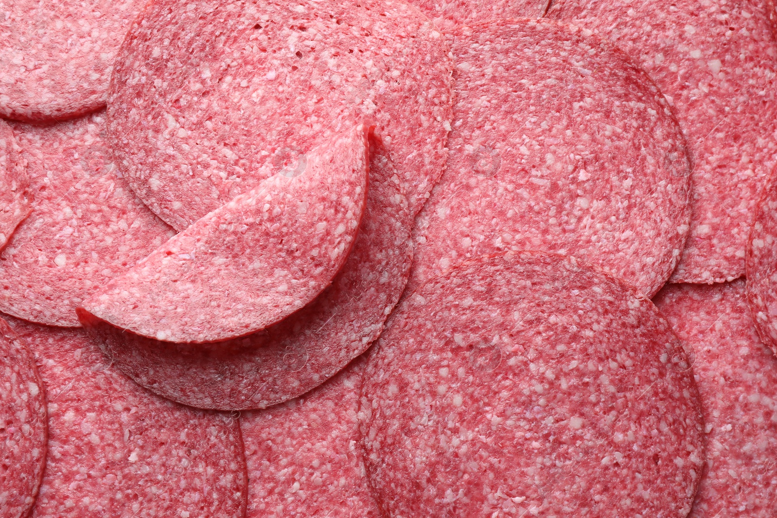 Photo of Slices of tasty smoked sausage as background, top view