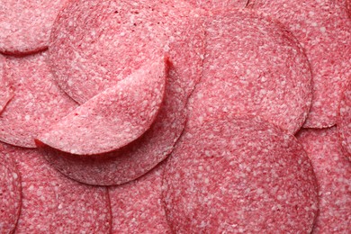 Photo of Slices of tasty smoked sausage as background, top view