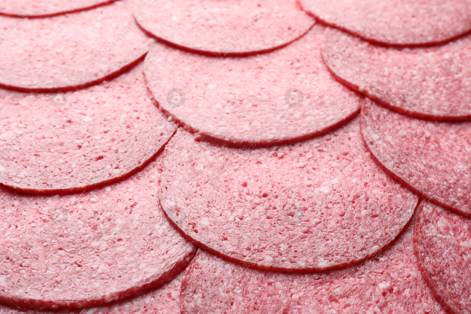 Slices of tasty smoked sausage as background, closeup Photo of Slices of tasty smoked sausage as background, closeup
