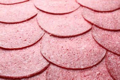 Photo of Slices of tasty smoked sausage as background, closeup