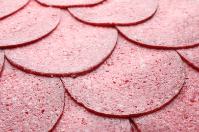 Photo of Slices of tasty smoked sausage as background, closeup