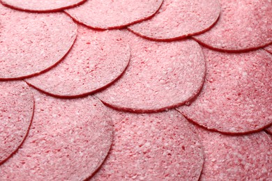 Photo of Slices of tasty smoked sausage as background, closeup