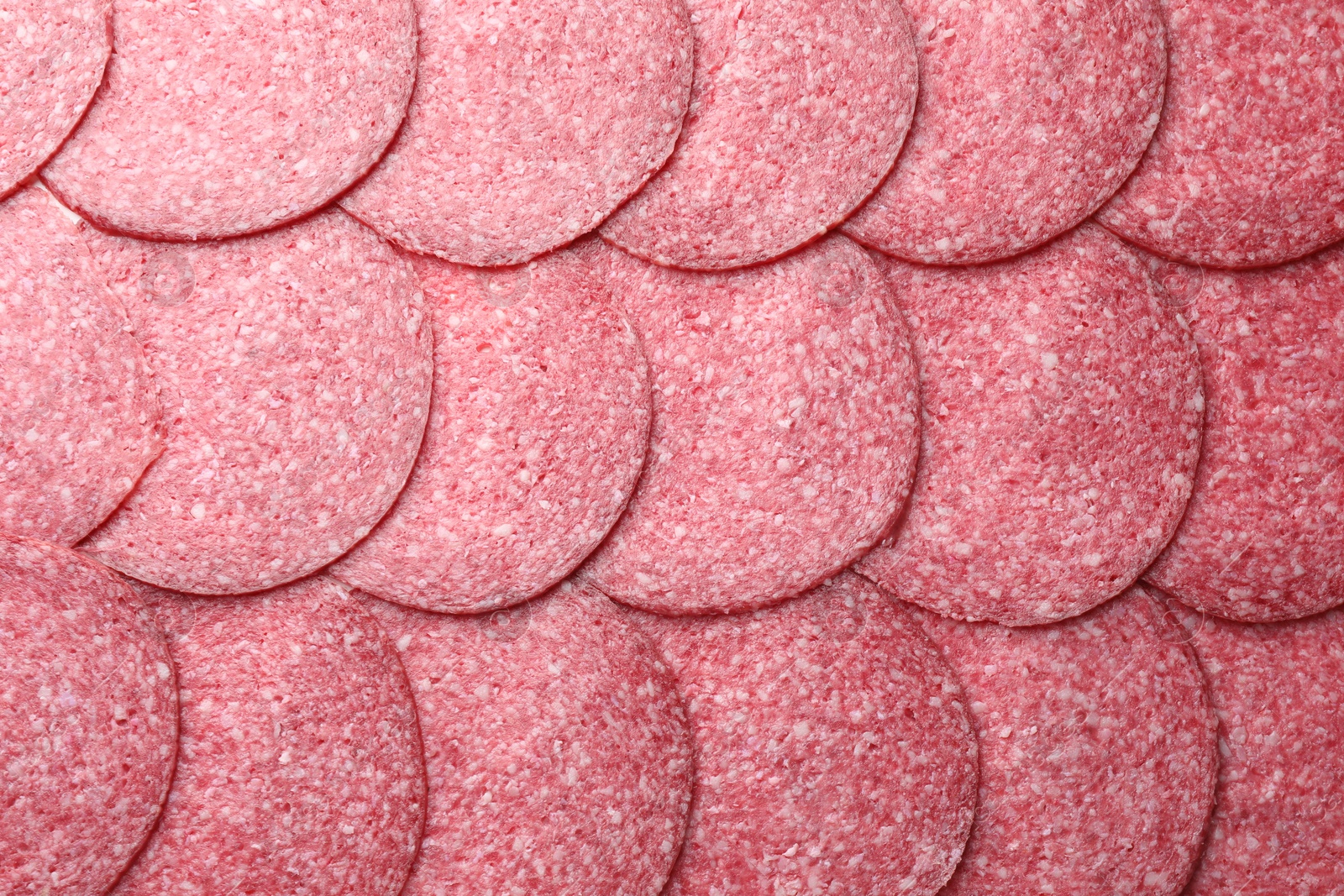 Photo of Slices of tasty smoked sausage as background, top view
