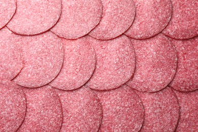 Photo of Slices of tasty smoked sausage as background, top view