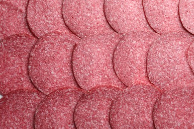 Photo of Slices of tasty smoked sausage as background, top view