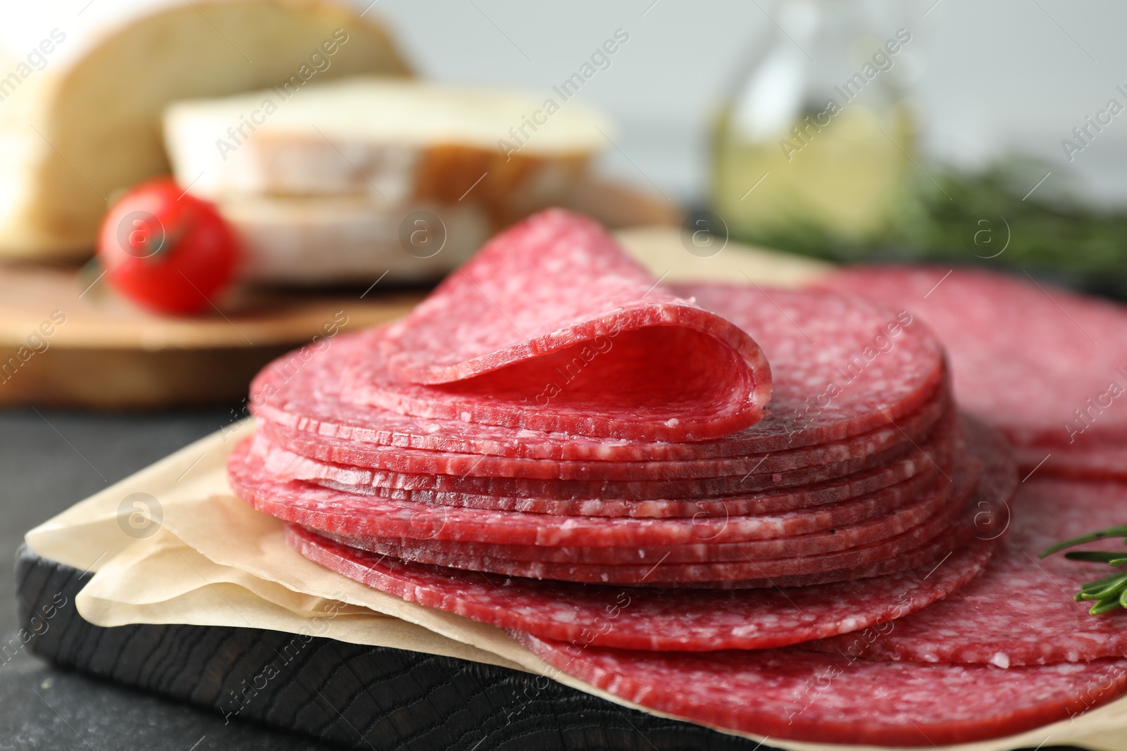 Slices of tasty smoked sausage on table, closeup Photo of Slices of tasty smoked sausage on table, closeup