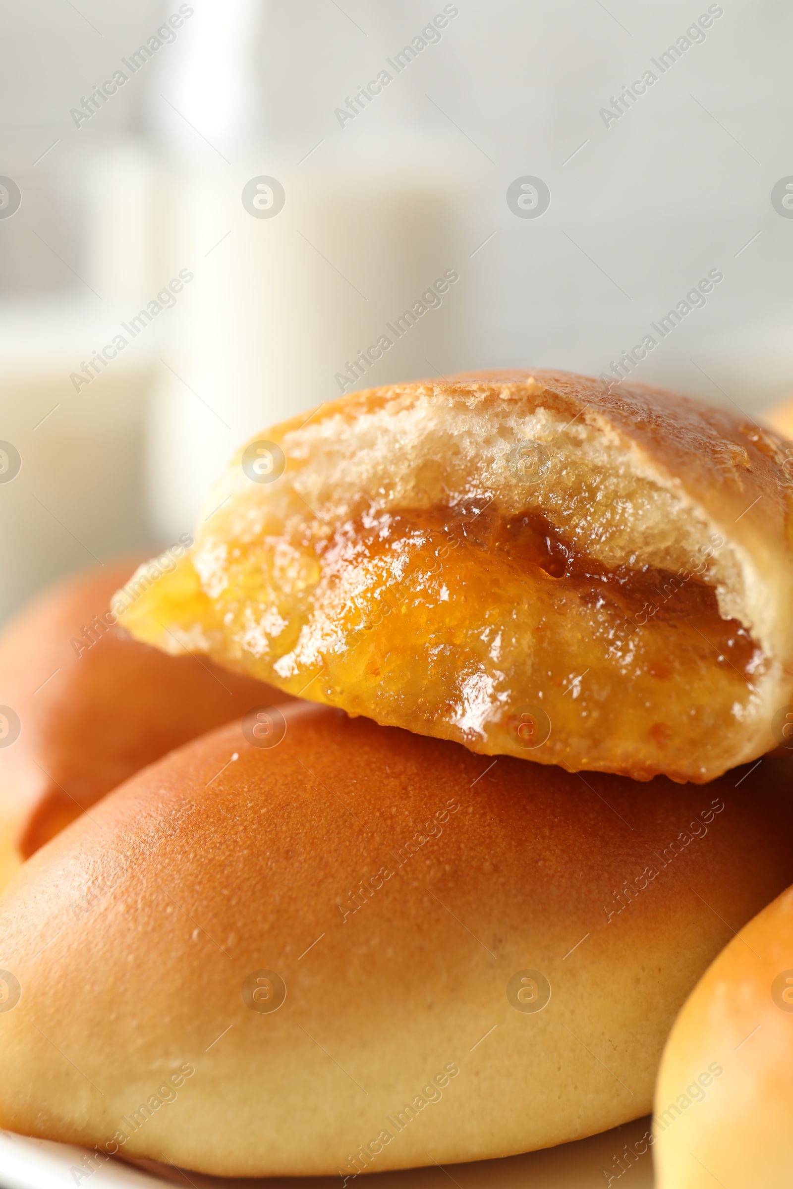 Tasty baked patties on plate against blurred background, closeup Photo of Tasty baked patties on plate against blurred background, closeup
