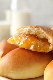 Photo of Tasty baked patties on plate against blurred background, closeup