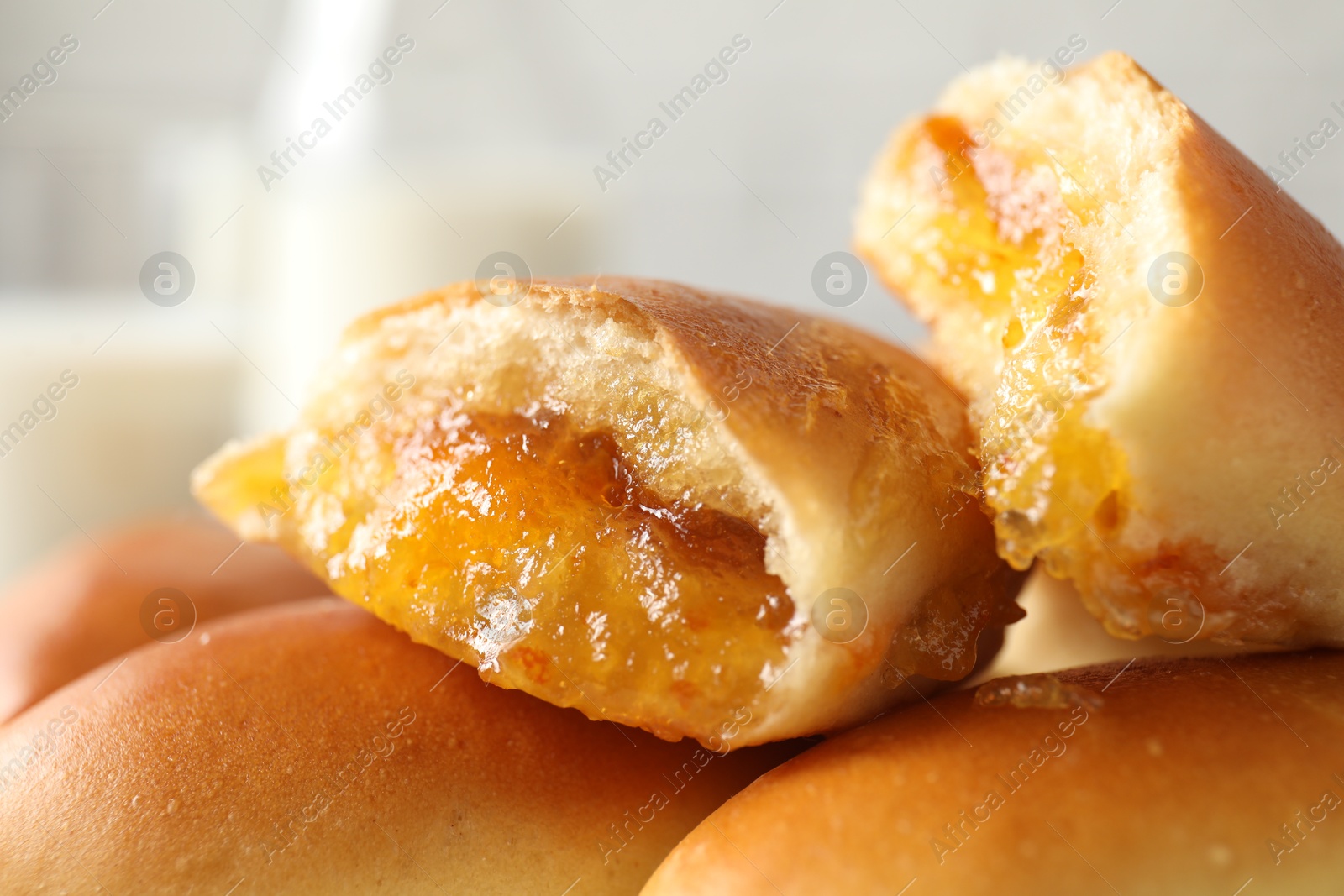 Tasty baked patties against blurred background, closeup Photo of Tasty baked patties against blurred background, closeup