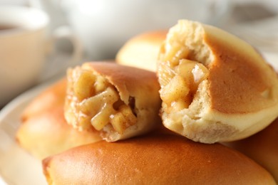 Photo of Tasty baked patties with apples on table, closeup