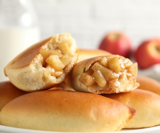 Photo of Tasty baked patties with apples on table, closeup