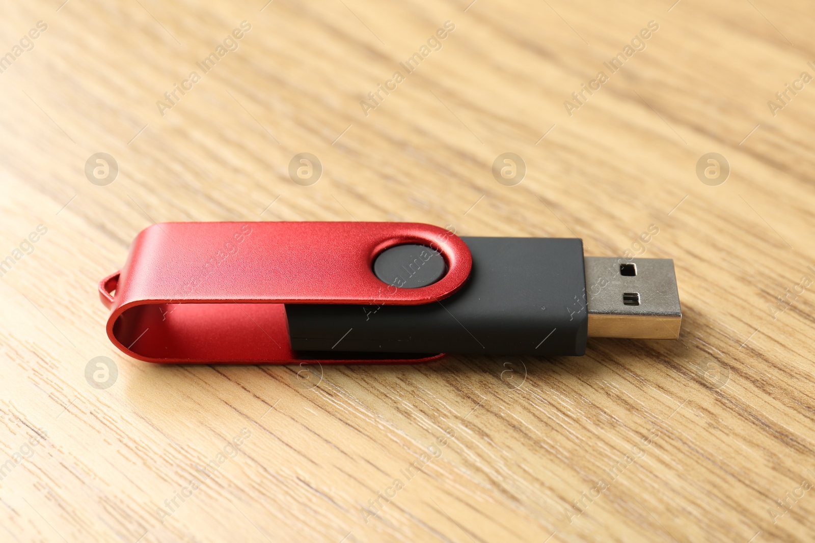 One flash drive on wooden background, closeup Photo of One flash drive on wooden background, closeup