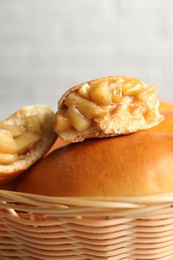 Photo of Tasty baked patties in wicker basket on blurred background, closeup