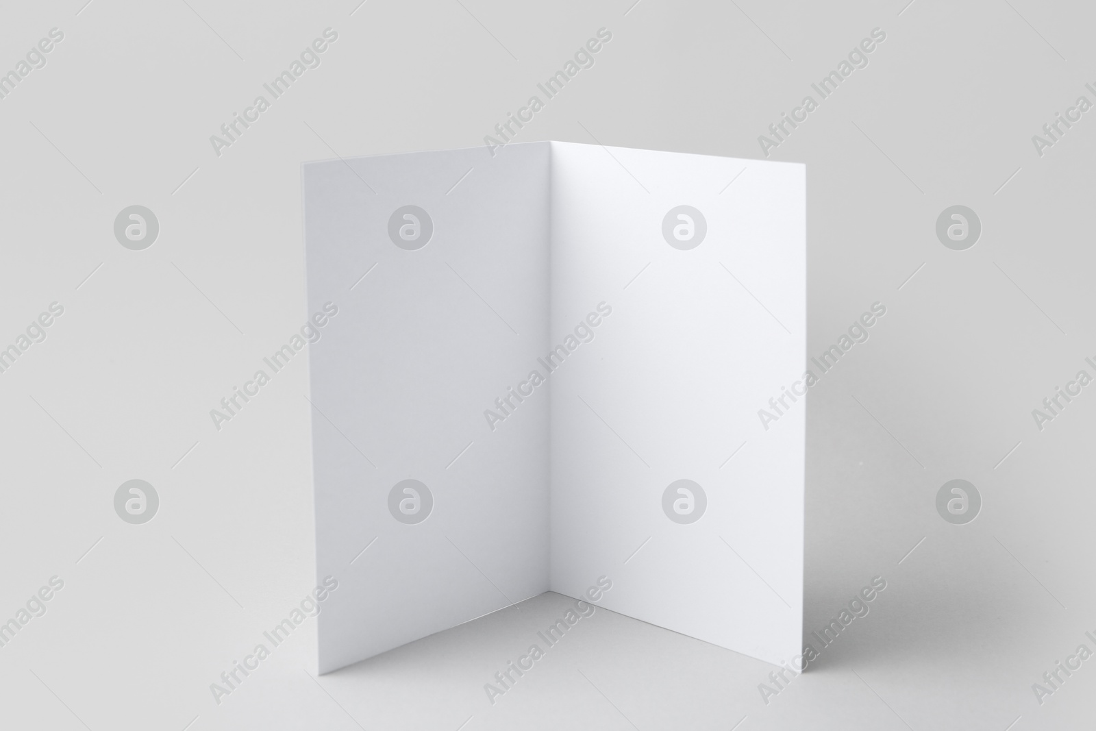 One blank greeting card on light background Photo of One blank greeting card on light background