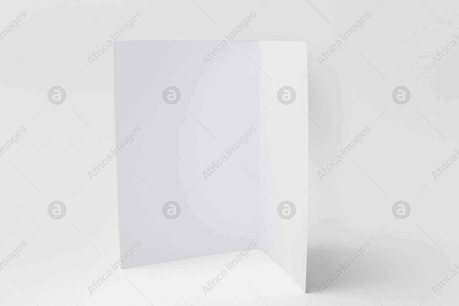Photo of One blank greeting card on light background