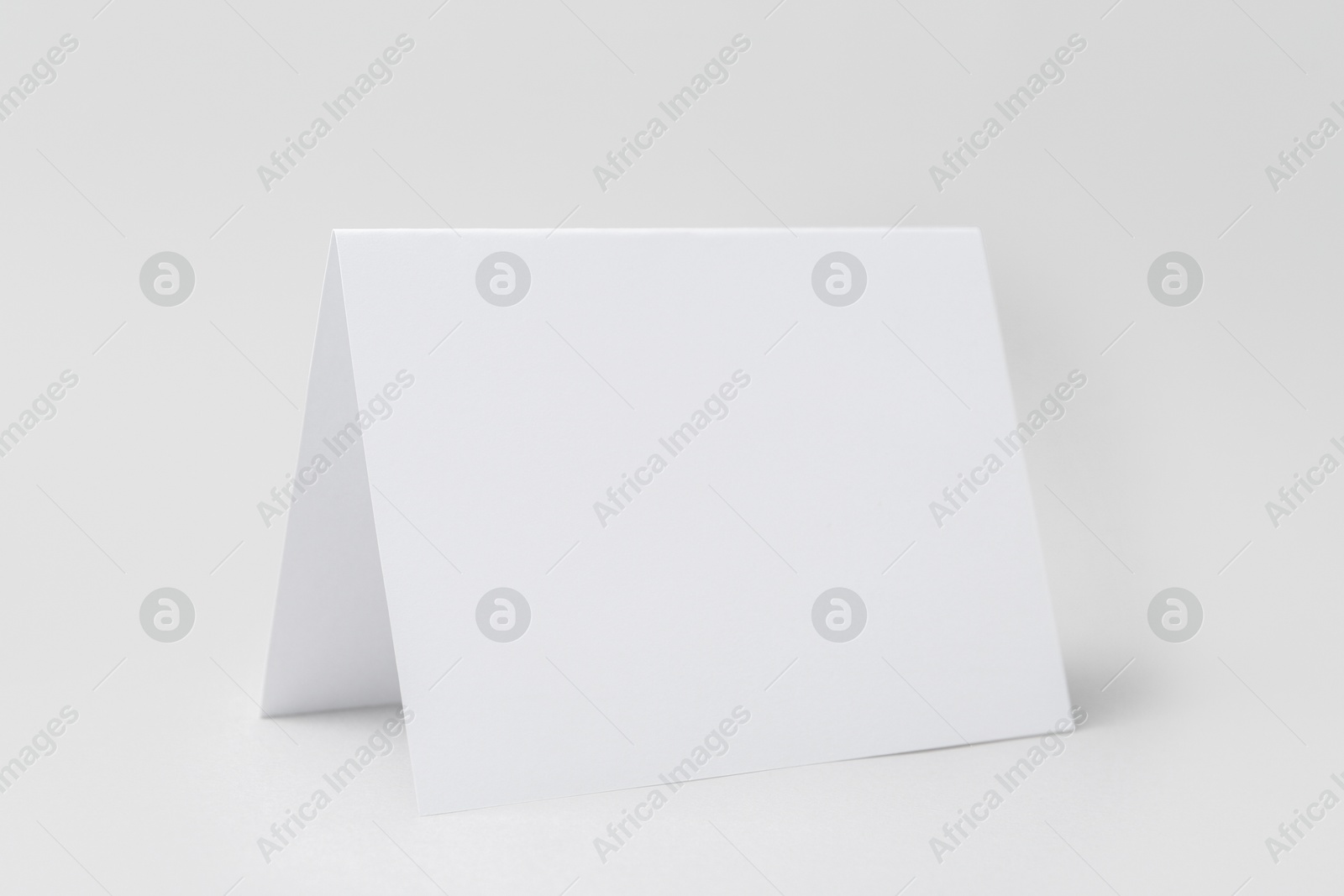 Photo of One blank greeting card on light background