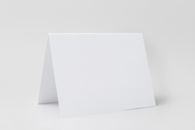 Photo of One blank greeting card on light background