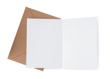 Photo of Blank greeting card and paper envelope on white background, top view