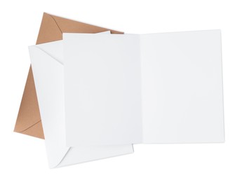 Photo of Blank greeting card and paper envelopes on white background, top view