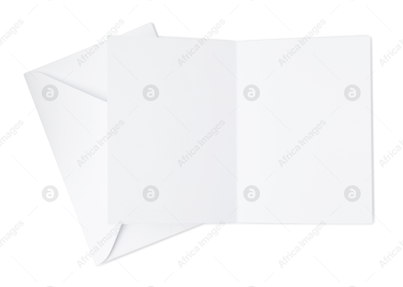Photo of Blank greeting card and paper envelope on white background, top view