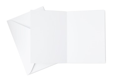 Photo of Blank greeting card and paper envelope on white background, top view