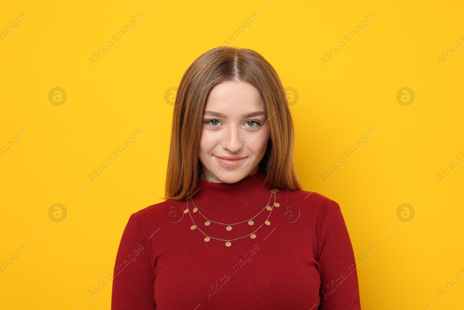Portrait of beautiful teenage girl on yellow background Photo of Portrait of beautiful teenage girl on yellow background