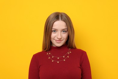 Photo of Portrait of beautiful teenage girl on yellow background