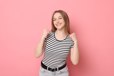 Photo of Portrait of smiling teenage girl on pink background