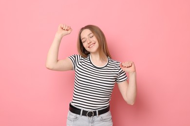 Photo of Portrait of smiling teenage girl on pink background