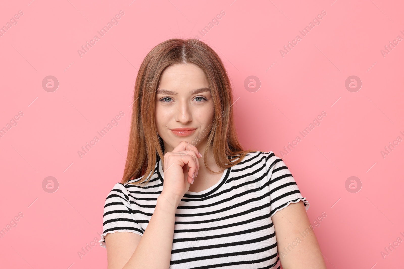 Portrait of beautiful teenage girl on pink background Photo of Portrait of beautiful teenage girl on pink background