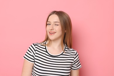 Photo of Portrait of smiling teenage girl on pink background